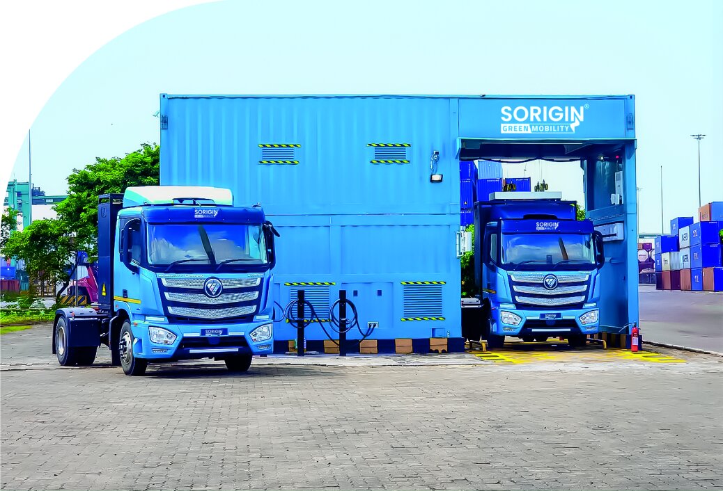 Sorigin electric trucks at a battery charging station in a port yard